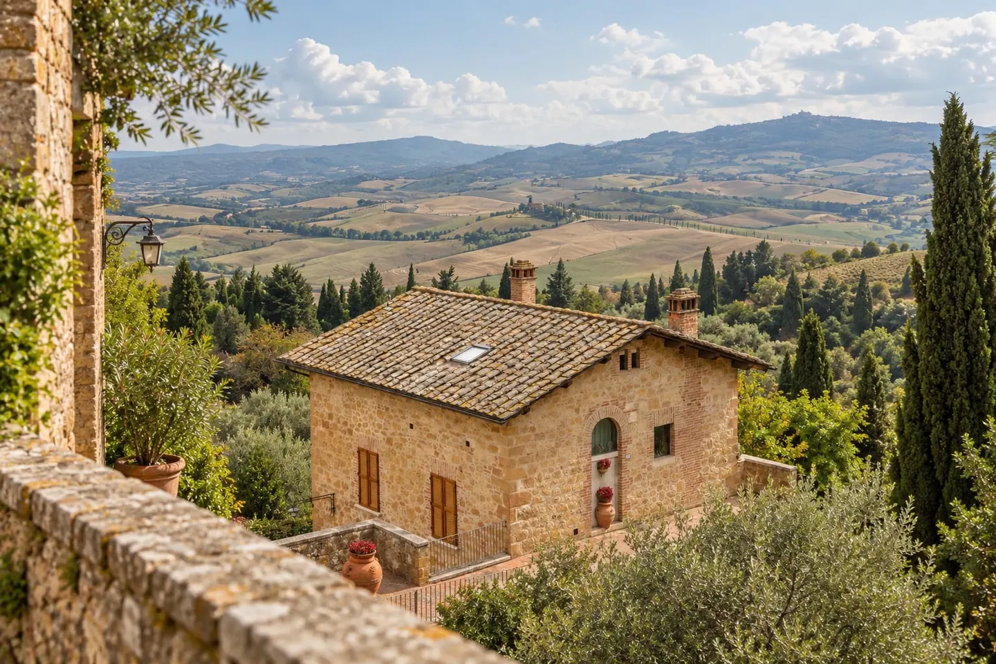 A stone house, cypress trees and hills near Pienza in the Val d’Orcia, Tuscany